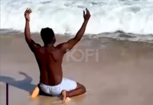 Funny Face cleanses himself at the sea after release from police custody