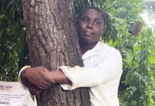 Ghanaian journalist hugs tree for 24 hours to break record and promote reforestation
