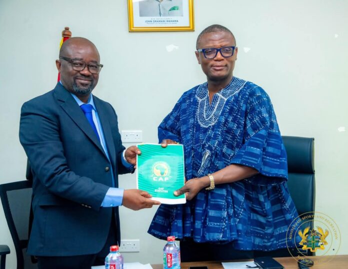 Kurt Okraku [L] was congratulated by Kofi Adams [R] on his recent CAF Executive Committee election
