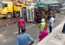 Cargo truck overturns on Circle overhead, crashes into sprinter bus
