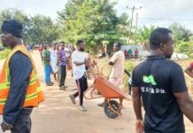 Security personnel join Akontombra residents to clean the town as part of National Sanitation Day exercise
